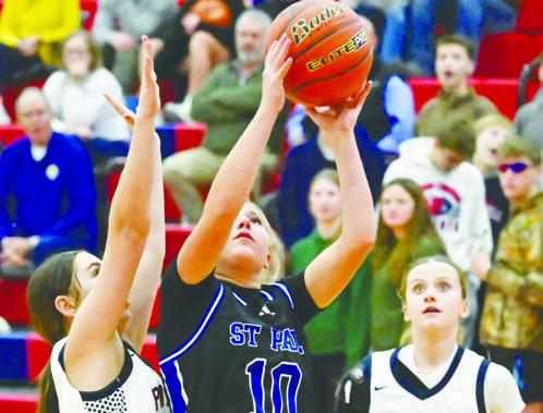 ALLI DUGAN battled for points in the paint during the Wildcats’ game against Adams Central. Dugan scored a pair for St. Paul during last week’s game. Photo by Michael Happ