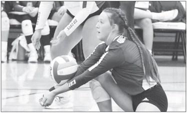 ST. PAUL’S KATIE OAKLEY digs up a shot from Adams Central during the opening set of last week’s match in Hastings. Photo by Michael Happ