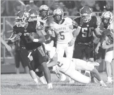 LEVI BADER attempts to shake off a Shamrock defender during the opening drive of the third quarter on Friday night. Bader had ten carries for forty-nine yards against Scotus Central Catholic. Photo by Michael Happ