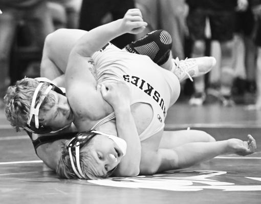 LANDYN RUBESH nearly pinned Elijah Fjell of Shelby-Rising City during the semifinals at 215-pounds on Friday. The Wildcat picked up a trio of back points with the maneuver, but still lost to the Husky 15-14. Photos by Michael Happ