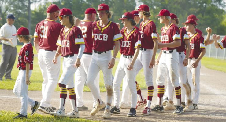 MEMBERS of the Danneborg-Cairo-Boelus (DCB) American Legion Baseball team congratulate each other after their championship in the Area C-6 District Tournament last month. DCB went on to place second in the state tournament. Photo by Michael Happ