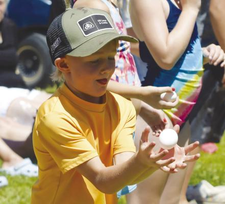 CHET DUGAN catches his egg during the youngest division of the egg toss on Saturday afternoon at Grossart’s Lot.
