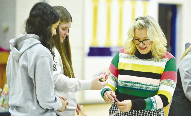 THE ST. PAUL ROTARY INTERACT CLUB held its annual gift wrapping fundraiser at St. Paul Public Schools on December 8th and December 15th. Students wrapped gifts as a part of the free-will-offering event, which netted the group in the ballpark of $350. Above, Zaya Lewis and Tessa Dugan work with Rotarian Katie Mathews during the event. Photo by Michael Happ