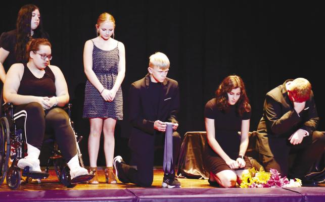 ACTING OUT A FUNERAL SCENE from At Any Moment during the drama department’s community performance are Reagan Adams, Klaira Rasmussen, Ayva Gregoski, Garrett Wells, Marissa Usasz, and Trevon Rasmussen. Photo by Michael Rother