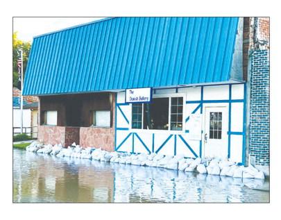 DANNEBROG residents, with the aid of volunteers, started sandbagging homes and businesses on Saturday to fend off rising water levels in Oak Creek. Courtesy Photo