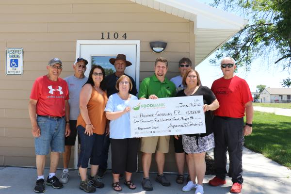 Pictured accepting a check at the Howard-Greeley Food Pantry last Wednesday were Keith Christensen, Steve Olsufka, Deanna Bauer (board member), Dean Keiborz, Lynda Connell (board member), Spencer Cohorst (Foodbank for the Heartland), Beth Svoboda, Sandi Mudloff (Executive Director), and Father Alex Borzych. (Michael Rother)