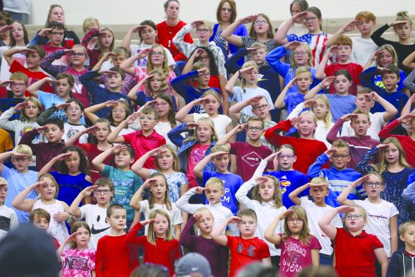 Students in the third and fourth grades at St. Paul Elementary School performed “The Stars and Stripes Forever” during last Friday morning’s Veterans Day program. (Courtney Leth)