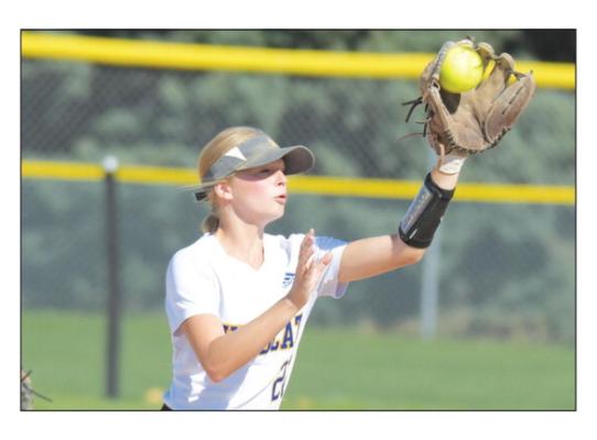 ST. PAUL’S KARLIE VIETH makes a play in the infield during last Friday morning’s game between the Wildcats and Grand Island Central Catholic. The Crusaders topped the Wildcats 9-2. Later in the tournament, St. Paul would also fall to Ord, with the Chanticleers winning the game 8-7. (Michael Happ)