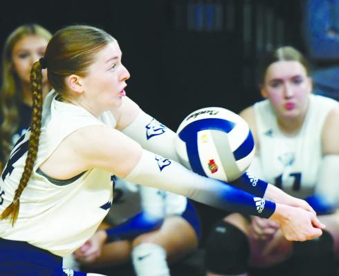 CAYLE GROSSART digs up a shot from Amherst during the Cougars’ quarterfinal match against Amherst. Grossart had eleven digs in the match. Photo by Jordan Coslor