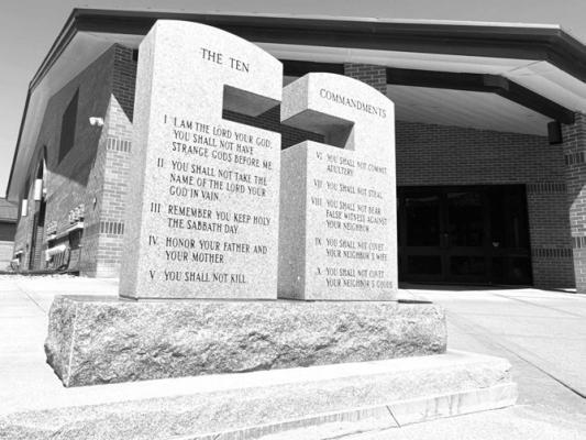 A STONE MONUMENT inscribed with the Ten Commandments and the Beatitudes was recently placed at the east entrance of Sts. Peter and Paul Catholic Church in St. Paul. The stone was donated by the Mel Kosmicki family and was dedicated following the 10:00 a.m. Mass on Sunday, May 24th. Photo by Michael Happ