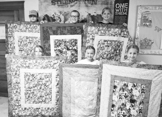SEVERAL of the participants in this year’s St. Paul Summer Rec sewing class show off the quilts they made during the program. Students met every Friday for two hours as a part of the program. Courtesy Photo