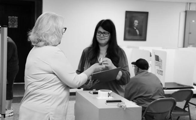 IMPORTANT LOCAL RACES in Howard County—including the race for county sheriff and for Commissioner District 3 representative on the Howard County Board of Commissioners—were decided during the Primary Election on Tuesday, May 12th. Voters came out early to make their voices known. Above, Renee Daily casts her ballot shortly after 8:00 a.m. on Tuesday and receives an “I Voted” sticker. Photo by Michael Rother
