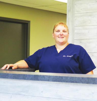DR. AMBER LUBBERS, the new veterinarian at Gage Valley Veterinary Clinic south of St. Paul, is pictured in the renovated reception area of the veterinary clinic along Highway 281. Dr. Lubbers said that the practice is starting to get established, noting that “the phone’s ringing.” (Michael Rother)