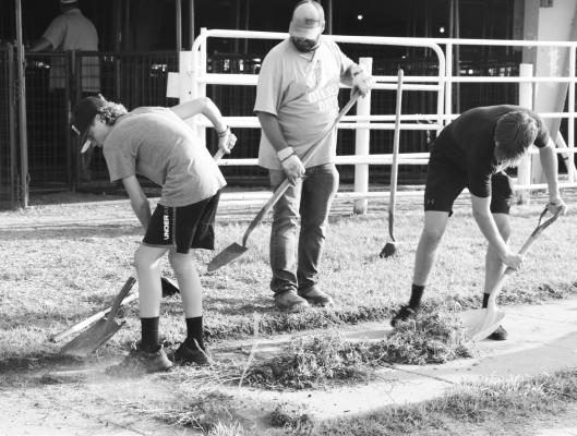 KIDS OF ALL AGES worked to prep the Howard County Fairgrounds for the upcoming county fair during Fair Clean-Up Night on Monday. A sizeable group of volunteers turned out to lend a hand during the event. Photo by Michael Rother