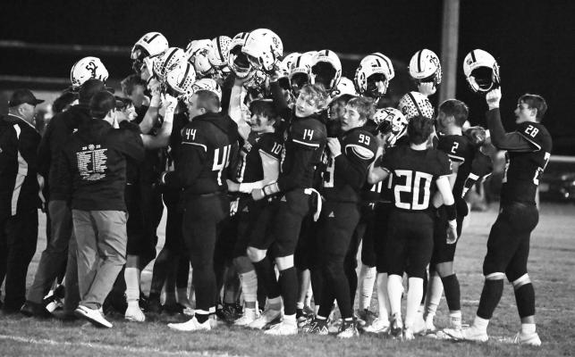 MEMBERS of the Central Valley football team celebrate Friday night’s quarterfinal victory over Archangels Catholic at midfield. The Cougars beat the Defenders 34-20. Photo by Jordan Coslor
