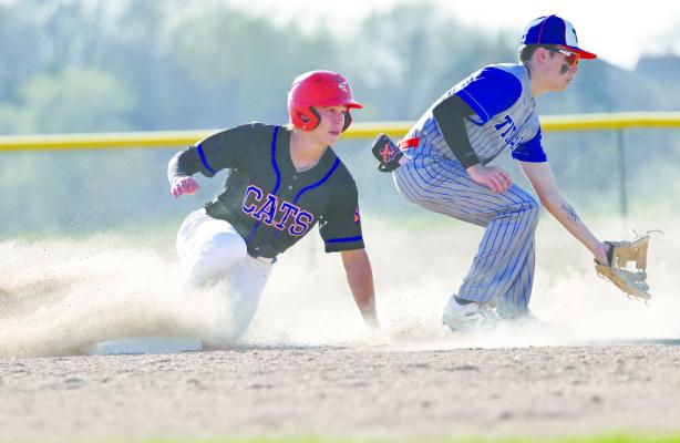 ST. PAUL/PALMER’S ALEX MEINECKE beats the throw to second base during last week’s game against Twin River. The Cats bested the Titans 5-4 for the come-from-behind win. Photo by Michael Happ