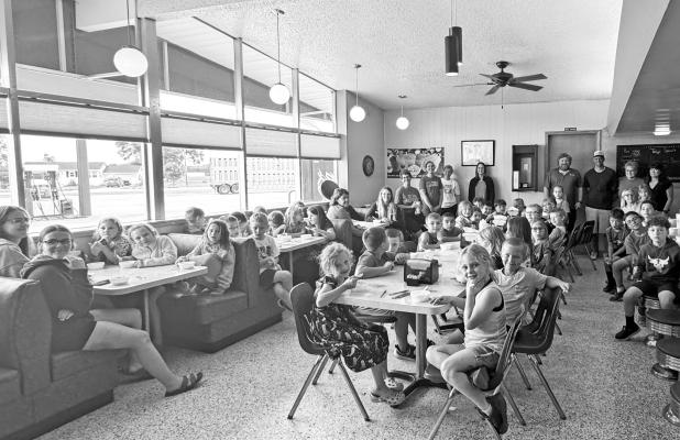 PARTICIPANTS in St. Paul Elementary School’s Summer School program were all smiles while they enjoyed ice cream at Skyline Café on Thursday. Pictured are the kindergarten, first, and second grade students, along with the program’s teachers and the café’s staff. Photo by Michael Happ