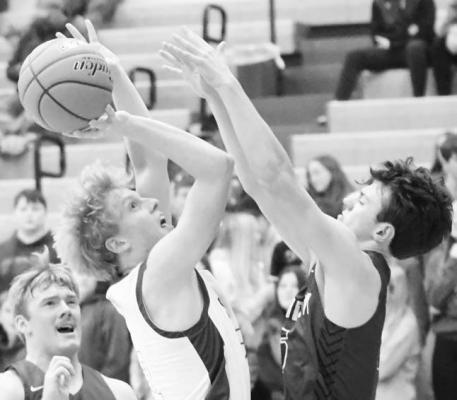 ST. PAUL senior Sam Kramer puts up a shot during the second quarter of last Tuesday night’s game against Minden. Kramer secured three points in last week’s game. (Michael Happ)