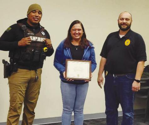 DANNEBROG PARAMEDIC EMILY WEBB was honored with a Life Saving Award last week. Presenting the award were St. Paul Police Officer Malik Bearheels and St. Paul Chief of Police Dan Howard. Courtesy photo
