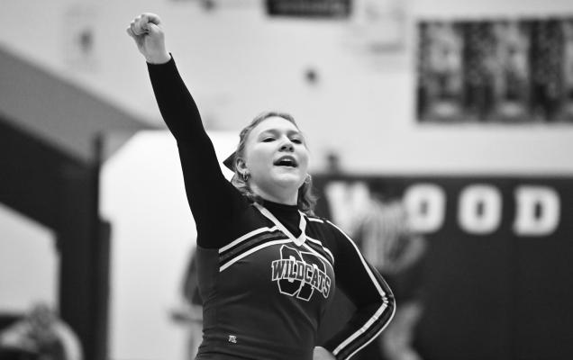 ST. PAUL FANS had plenty to cheer for last Thursday night when the Wildcats’ girls’ basketball team improved to 3-0 on the season with a last-second victory over Wood River. Above, Lily Sazama helps lead Wildcat fans in a cheer during a break in last week’s action. Photo by Michael Happ