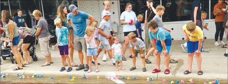 KIDS AND ADULTS of all ages raced along Howard Avenue during the duck races on Friday night. The races were well-attended.