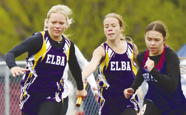 ELBA’S Marena Paczosa makes an exchange with Addyson Wysocki during the girls’ 400-meter relay at last week’s Palmer Invitational. The Bluejays placed seventh in that race at 57.50. Photos by Jordan Coslor