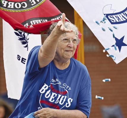 MARY REIMERS tosses candy from atop the American Legion’s entry in this year’s Boelus Days parade.