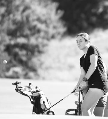 KATELYNN ALBERS watches her chip shot last Tuesday on the course at Valley View Golf Course north of Gibbon. Photos by Jordan Coslor