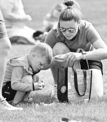 CHET WALCH and his mom, Hannah, sort through the candy they gathered at the St. Paul Area Chamber of Commerce’s Easter Egg Hunt last week.