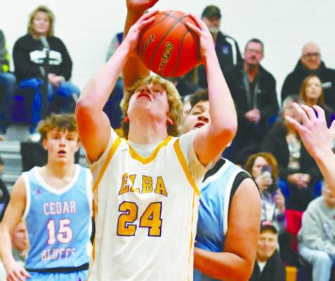 ELBA’S BLADEN RATHMAN fights past a Cedar Bluffs defender on Friday night in Elba. Rathman had fourteen points in the Bluejays’ loss to the Wildcats last week. Photo by Michael Happ