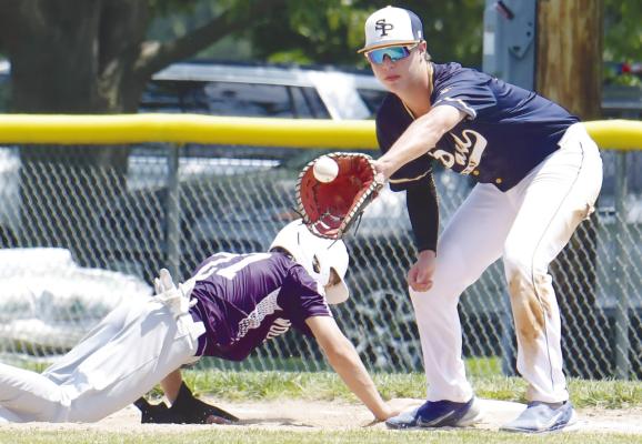 ST. PAUL first baseman Braxton Heater attempts to pick off a Wood River baserunner during last Friday’s opening round game of the Area C-5 Tournament at Silver Creek. Courtesy Photo