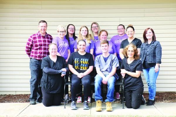 FAMILY PET CLINIC staff members include (back row): Dr. Adrian Anderson, Kate Voravong, Nicole Dahmer, and Lizabeth Reimers; (middle row): Deb Schmidt, Jace Brandenburge, Nat Menke, Kati Green, and Tracy Anderson; (front row): Teresa Muckey, Audrey Anderson, Aidan Anderson, and Shirley Webb. (Michael Rother)
