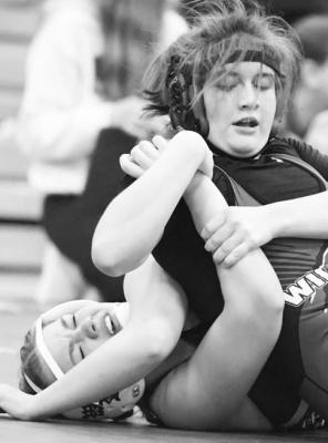 ST. PAUL’S Lauren Sladek works to pin Wood River’s Caitlin Stafford on Saturday. Sladek bested the Eagle 10-7. (Michael Happ)