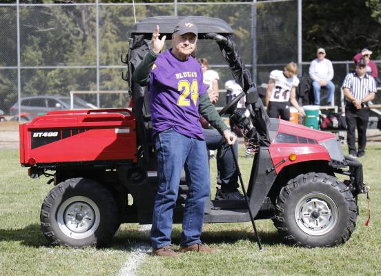 RANDY RASMUSSEN waves to the crowd prior to the start of Friday afternoon’s homecoming football game in Elba. (Michael Rother)