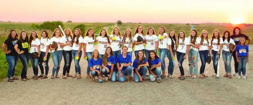 The 2022 Wildcat Softball team includes, front row kneeling, Kyndel Sack, Annie Stepanek, Katie Kleinsasser, Ava Petersen, and Emmy Vech; back row, Coach Holdsworth, Coach Svoboda, Ella Petersen, Morgan Hawley, Jorja Vokes, Avery Hansel, Brooke Peetz, Norah Paulsen, Kayley Wells, Talyr Paxton, Karlie Vieth, Sidney Gawrych, Matti Stepanek, Charlee Wegner, Annie McClay, Addy Wegner, Audra Dugan, Tavyn Anderson, Kamden Sack, Natalia Matlock, Coach Volk, and Tage Anderson. Not pictured is Dave Prokesh, Johannah