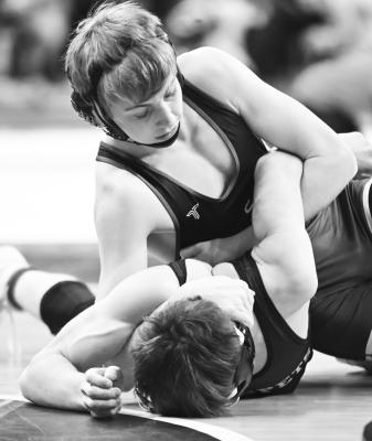 LAYNE BAKER attempts to put Minden’s Harrison Reed on his back during the quarterfinal round of the NSAA State Wrestling championships in Omaha on Thursday. The Wildcat beat the Whippet 10-3. Photos by Michael Happ