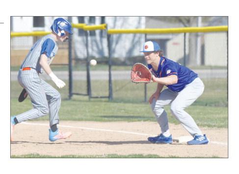ST. PAUL/PALMER first baseman Ashton Meinecke attempts to pick off a Twin River baserunner last Tuesday during the Cats’ game against the Titans in Genoa. Photo by Michael Happ