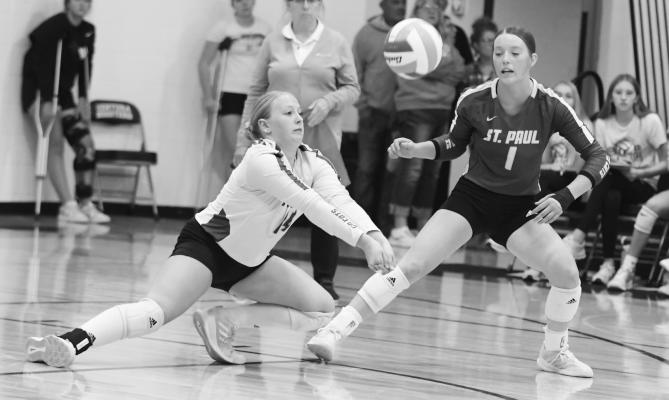 DELANEY JENNINGS digs up a shot during last week’s consolation finals against Ravenna with Katie Oakley looking on. Photos by Michael Happ