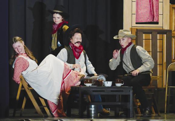 CANDY KANE (Hope McDonald, left) nearly puts her kidnappers—including KyAnna Brand, Ella Simon, and Carson Harder—out of commission after they steal one of her boots during a staging of Westward, WHOA! earlier this season. Photo by Michael Rother