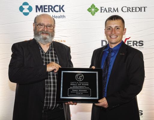 TERRY WEGNER, who received the Arturo Armendariz Distinguished Service Award for feedyard employees at the 2023 Cattle Feeders Hall of Fame Banquet in New Orleans, Louisiana, is pictured receiving the award from his employer, Sam Drinnin, yard manager at Drinnin West Cattle Co. in Palmer. (Courtesy Photo)