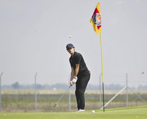 CENTURA’S JACK HADENFELDT chips on to the second green at Jackrabbit Run Golf Course in Grand Island on Friday morning. Photo by Michael Happ