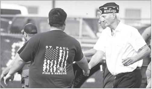 HAROLD SCHENCK with the Carl Mogensen American Legion Post 119 in St. Paul shakes the hand of St. Paul Volunteer Firefighter Tyler Moslander following Friday afternoon’s September 11th remembrance ceremony. Photo by Michael Happ