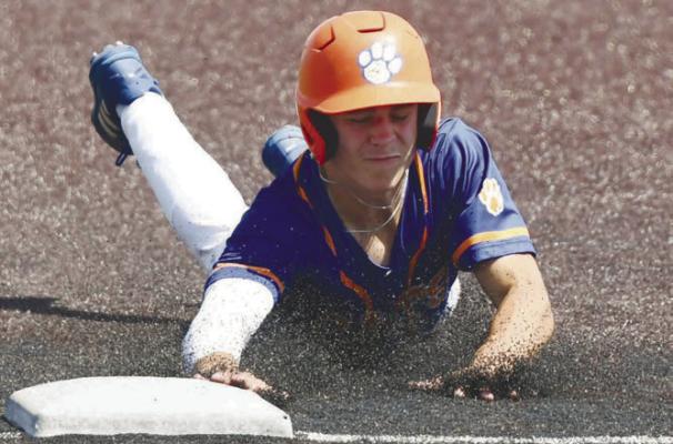 RUBBER FLIES on the artificial surface at Papillion-La Vista South High School on Saturday morning as Alex Meinecke dives back to first base to avoid being picked off by Central City/Centura. Photo by Jordan Coslor