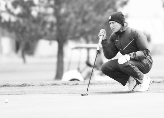 ST. PAUL’S SAWYER KAVAN lines up his shot at the District C-4 Golf Meet in Grand Island last Tuesday afternoon.