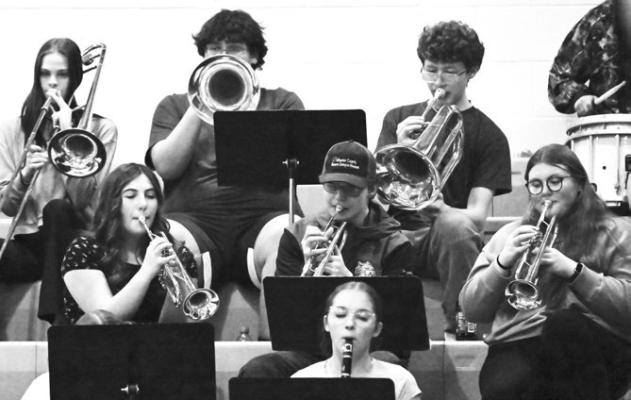 THE ST. PAUL PEP BAND got a boost from a host of familiar faces last Tuesday night. The musical group welcomed back alumni to play as a part of the band during the Wildcats’ basketball games against Columbus Scotus High School. Photo by Michael Happ