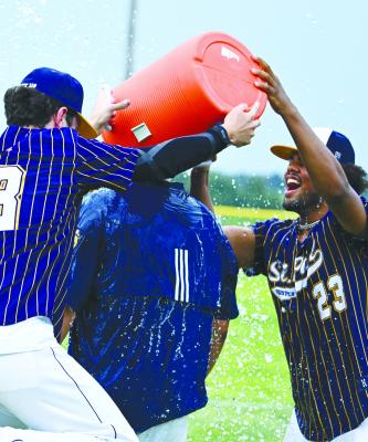 ST. PAUL’S PARKER LENTZ AND LEVI BADER celebrate winning the Area C-6 Tournament championship by showering Head Coach Trae Anderson following last Tuesday’s game at Grover Cleveland Alexander Field in St. Paul. Photo by Michael Happ