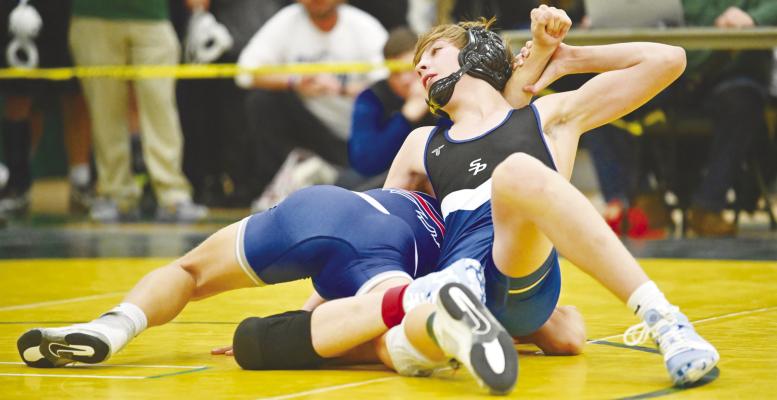 ST. PAUL’S LAYNE BAKER needed just two minutes to pin Lukas Altwine Adams of Gibbon in the semifinals of the District C-4 Tournament at Kearney Catholic on Saturday. Baker ended up being one of the Wildcats’ three district champions last week. Photos by Michael Happ