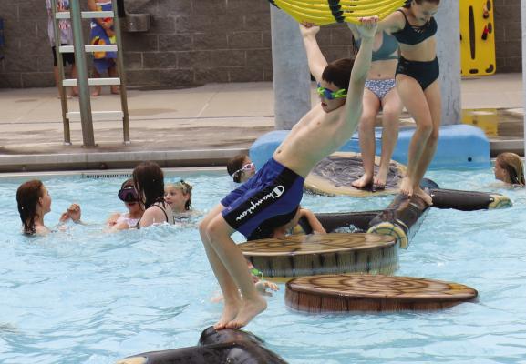 KIDS OF ALL AGES enjoyed the many amenities offered by the St. Paul Water Park on the facility’s opening day last month. Warm weather has helped attendance early on in the water park’s season. Haley Spotanski