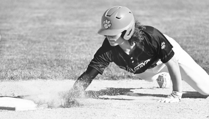 ZANYDN WELLER avoids being picked off of first base during the first inning of the second game of last Thursday night’s doubleheader in Aurora. The Cats beat the Huskies in both games last week. Photo by Michael Happ