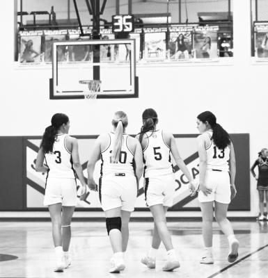 THE SHOT CLOCK was introduced to the smallest four classes in Nebraska high school basketball this year. Above, clocks are rest to thirty-five seconds following a timeout during the St. Paul girls’ game against Gibbon last Thursday. Photo by Michael Happ